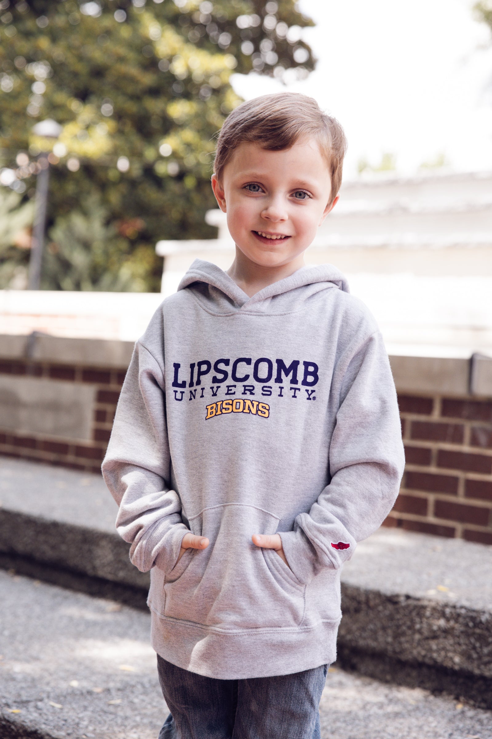 Child wearing a Lipscomb University hoodie outdoors.