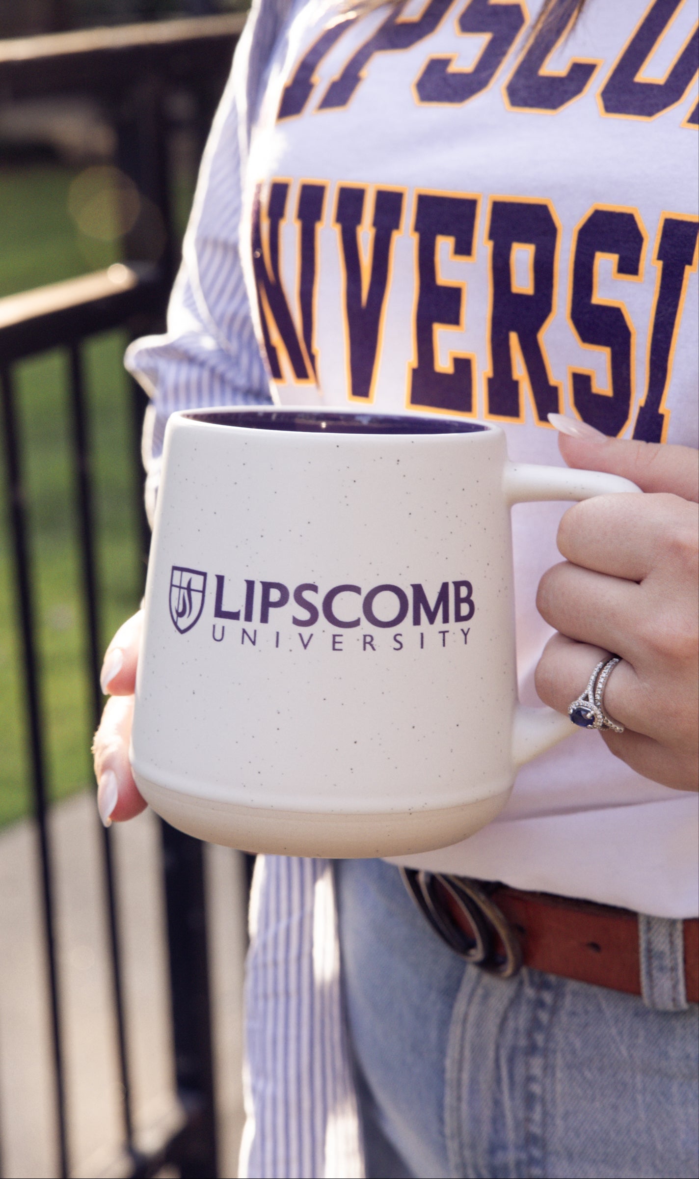 Person holding a Lipscomb University mug with a outdoor background